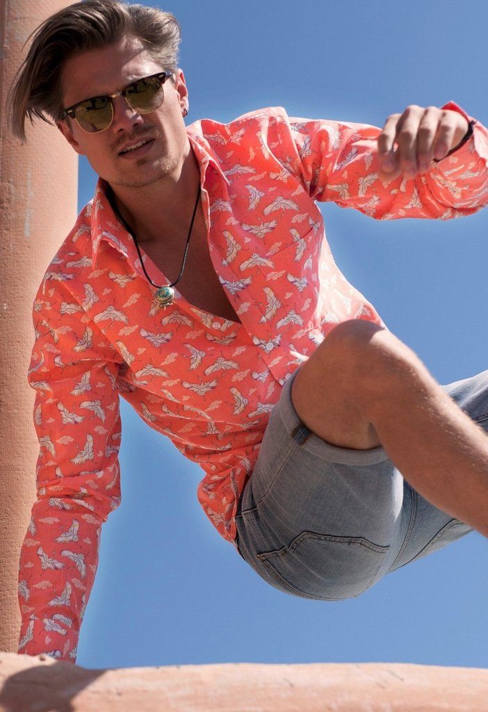 man wearing frangipani style festival shirt