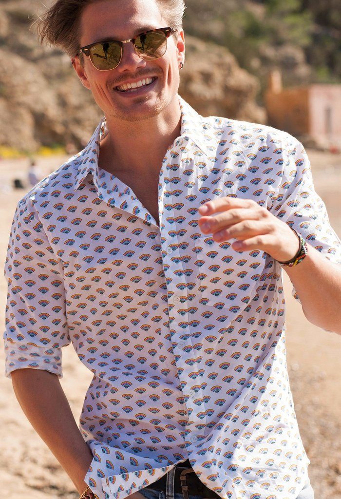 man wearing frangipani style festival shirt