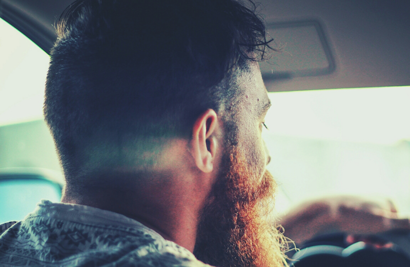 bearded man driving car