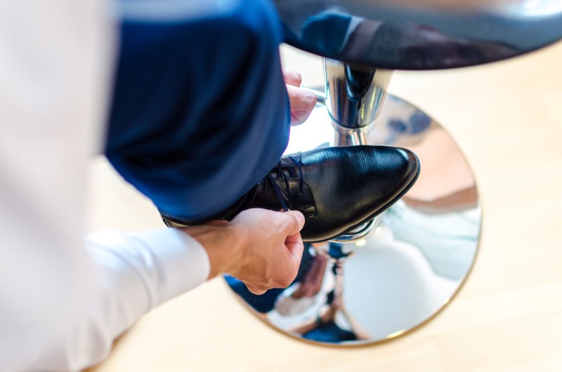 man putting on smart shoe