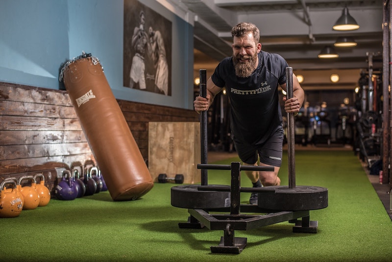 bearded man working out at gym 