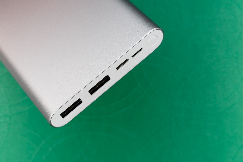 Silver power bank with green background