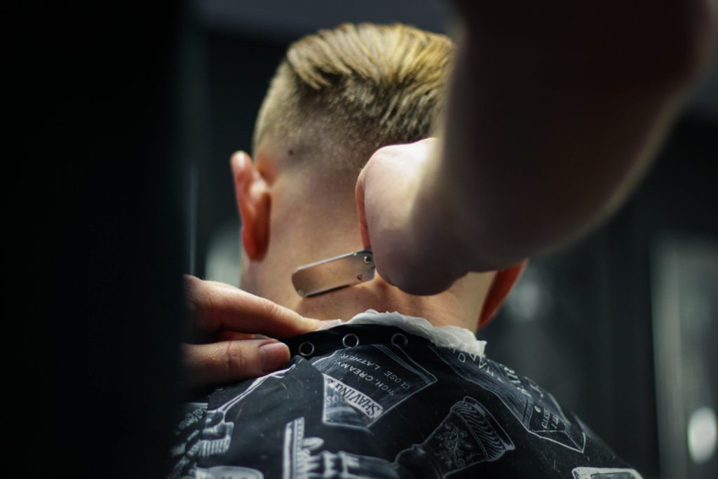 man getting neck trimmed with razor