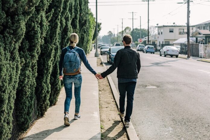 Couple walking down street holding hands