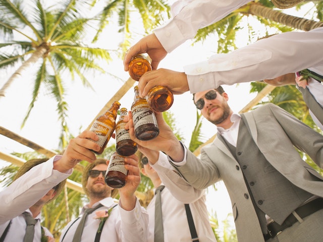 men drinking in suits