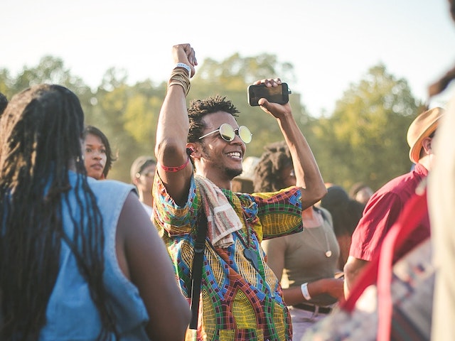 man celebrating at a festival with snazzy shirt